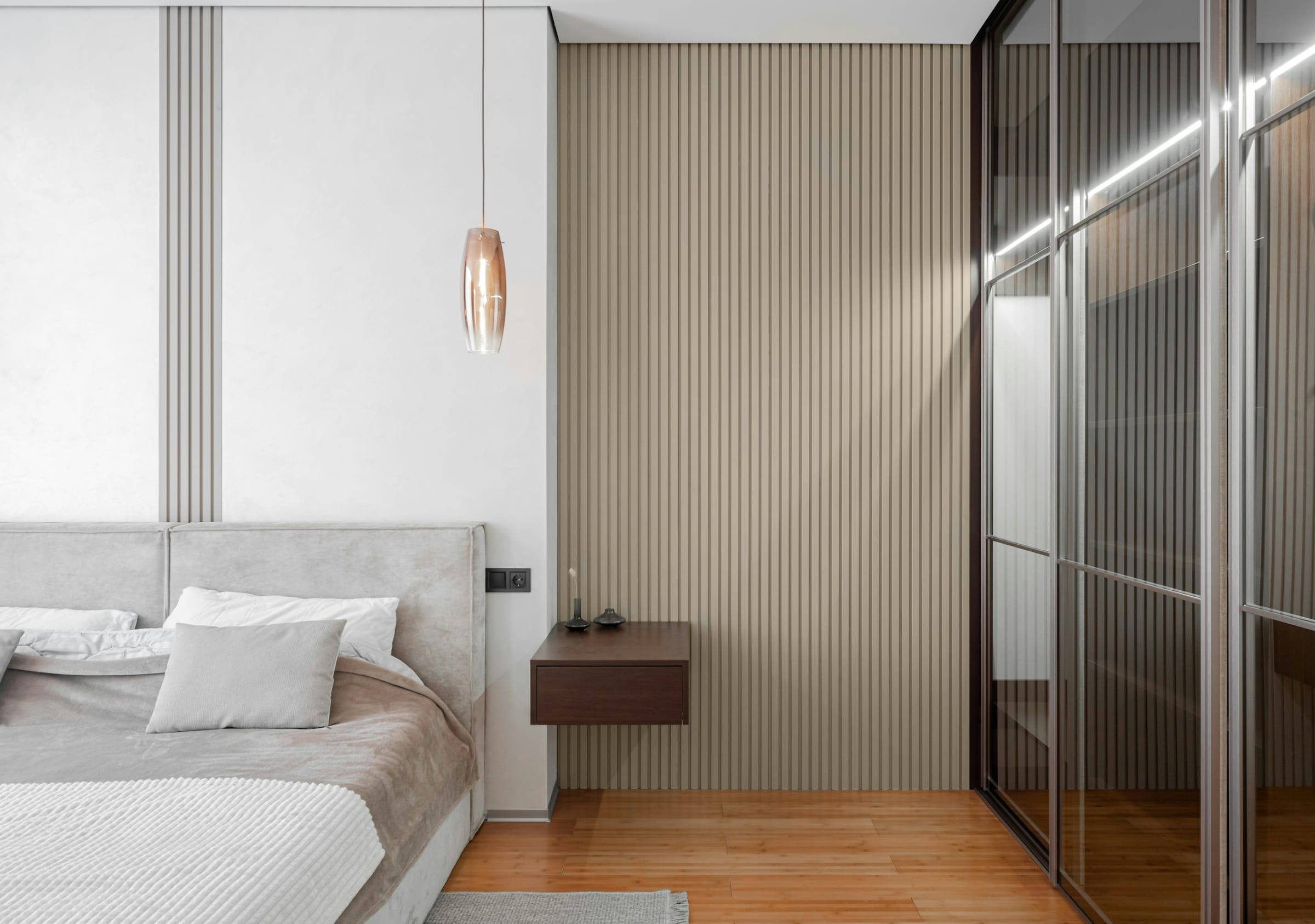 A calm, minimalist bedroom with smoothly finished walls in muted tones.