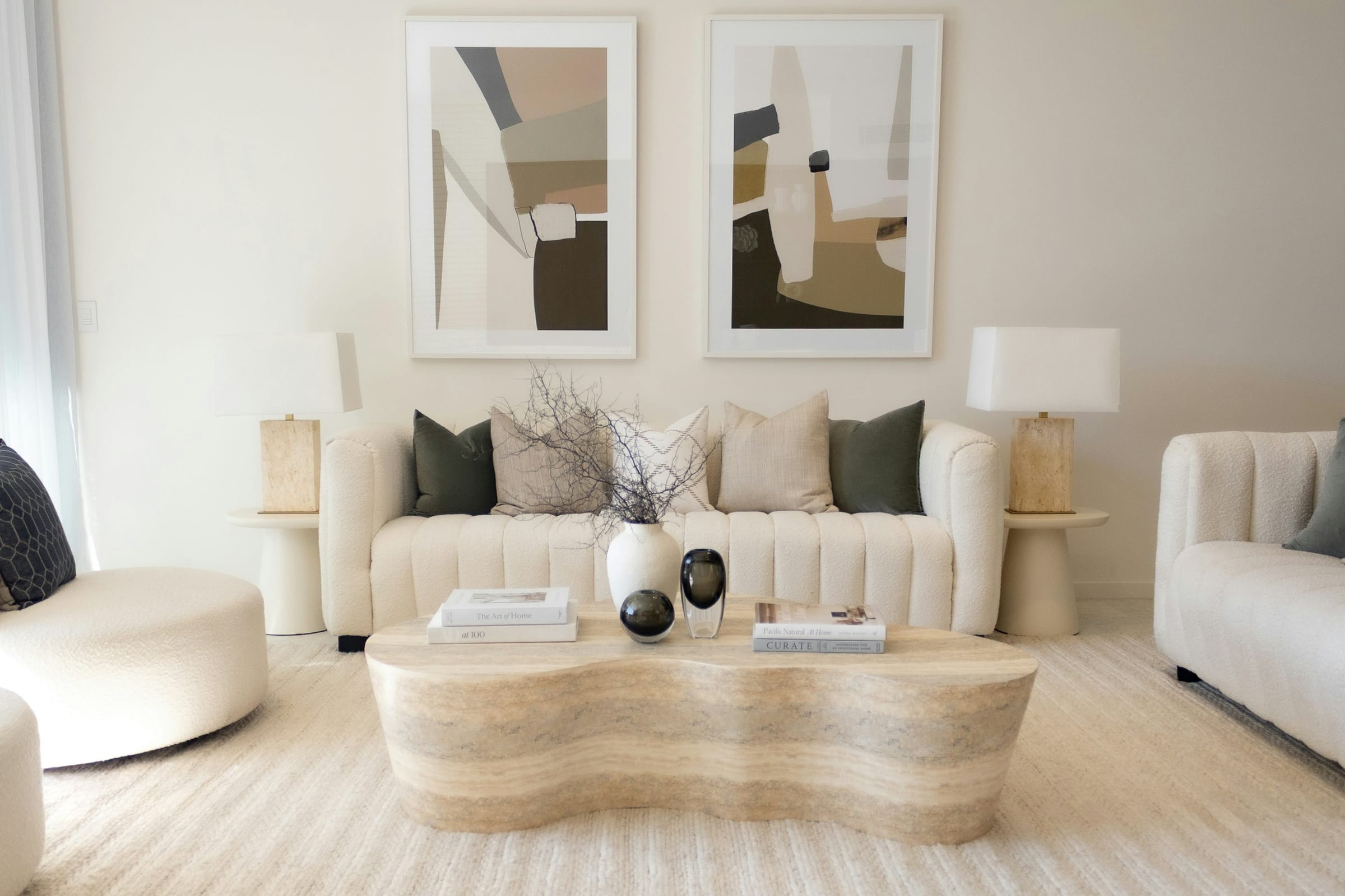 An elegant living room with softly painted neutral walls and warm natural light.